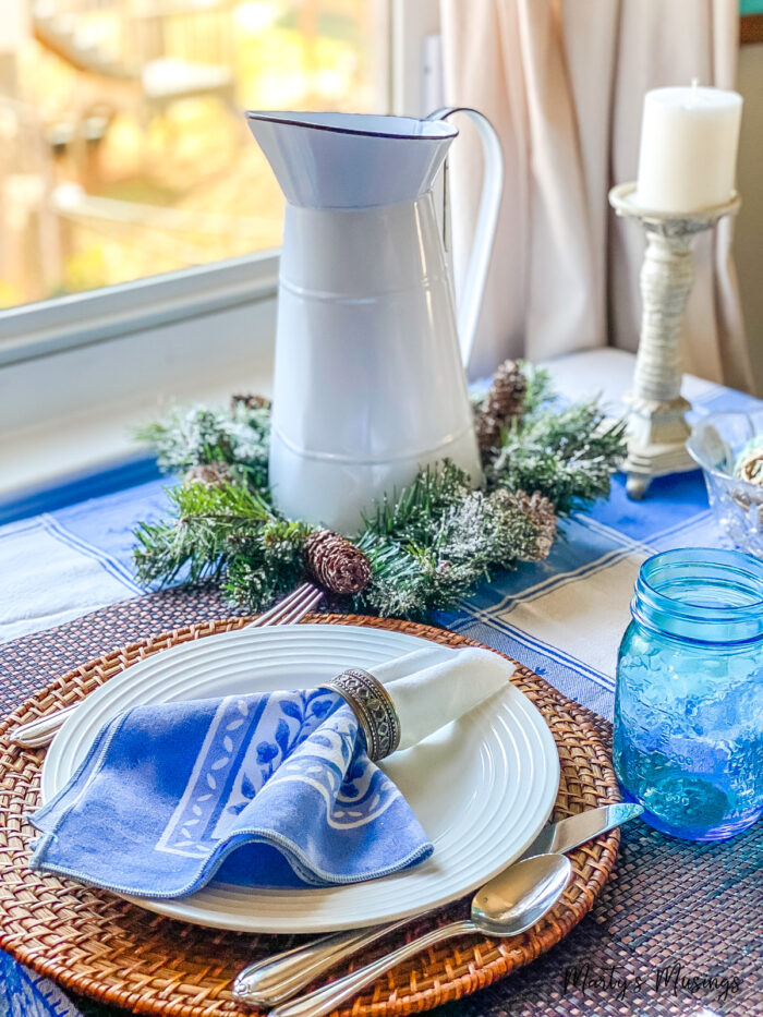 Blue winter tablecloth with blue accents on small dining table