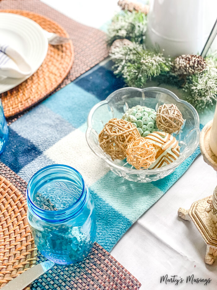 Blue throw used on small kitchen table with blue accents