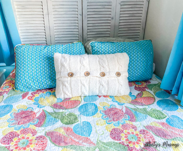 closet door headboard with aqua patterned quilt