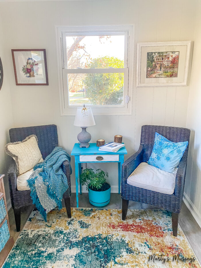 Two black wicker chairs with winter pillows