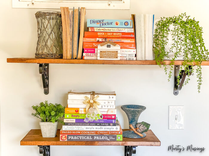 Shelves filled with cookbooks and greenery