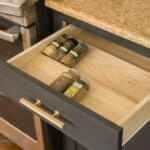 Everyday spices in an open kitchen drawer