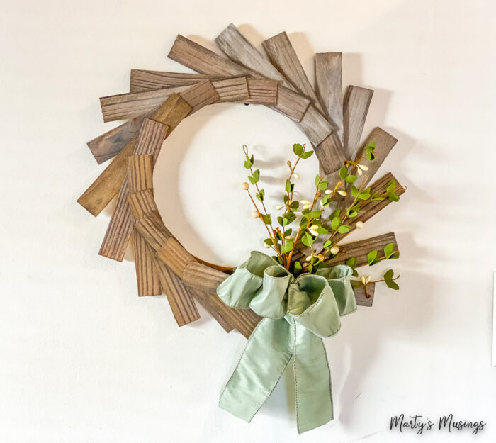 Wood shim wreath with green ribbon and flowers