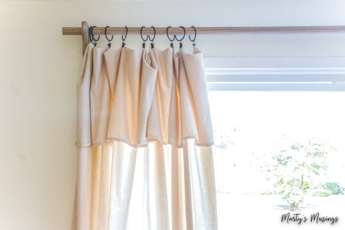 Drop cloth curtains bunched to one side