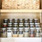 Riser in kitchen cabinet for spice jars with black labels