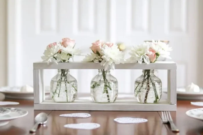 White wooden box with glassware and flowers 