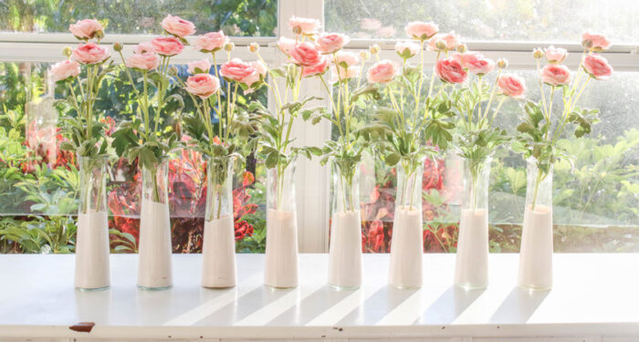Dollar store glass bottles dyed pink with pink flowers