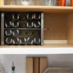 spices organized in cabinet with black lids