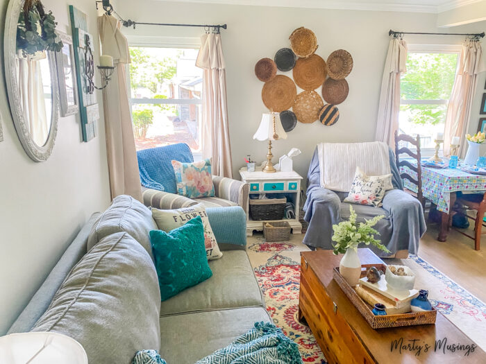 Small cottage living room decorated in blues with a basket wall