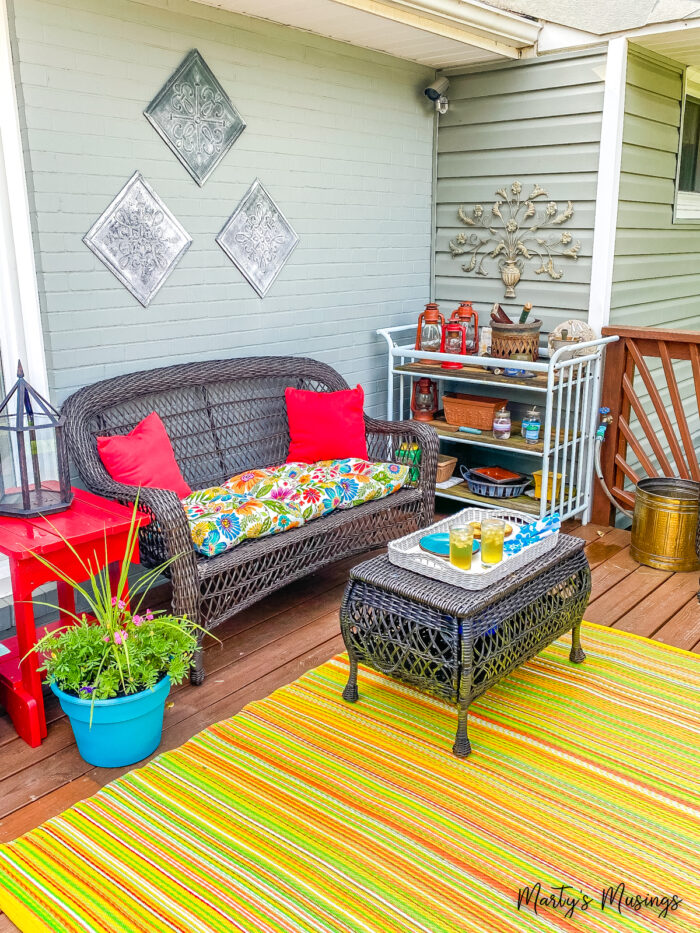 Front deck with colorful pillows and rug