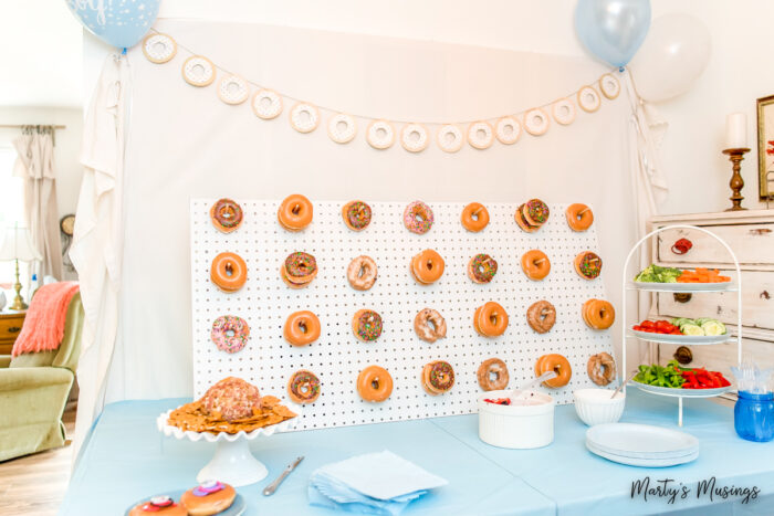 Pegboard with donuts hanging and donut banner above