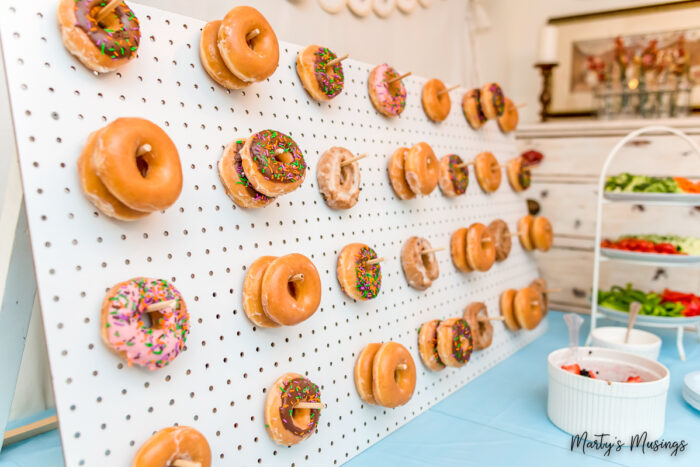 White pegboard with donuts hanging from pegs