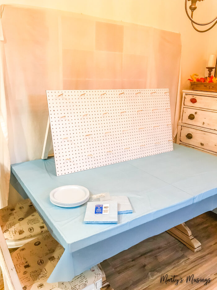 White pegboard sitting on blue tablecloth 