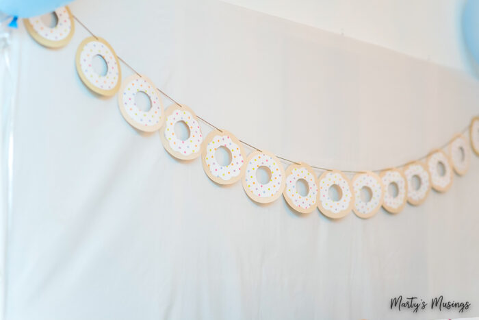 Donut banner hanging from white sheet