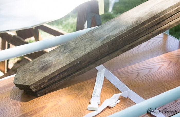 Fence board slats on top of press board wood