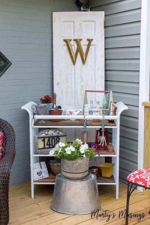 Potting bench with door behind it and outdoor decor