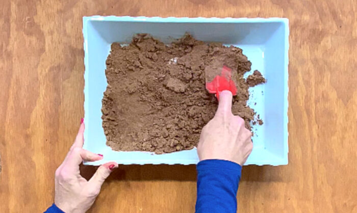 Press cake mix and butter into baking dish