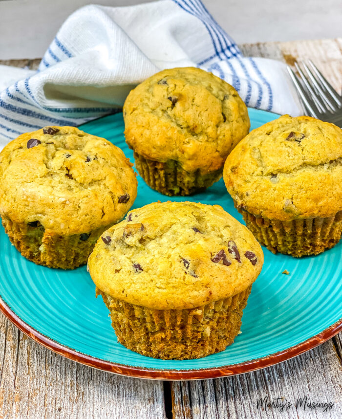 Chocolate chip banana muffins on blue plate