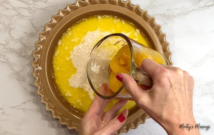 Pour peaches into pie plate filled with butter