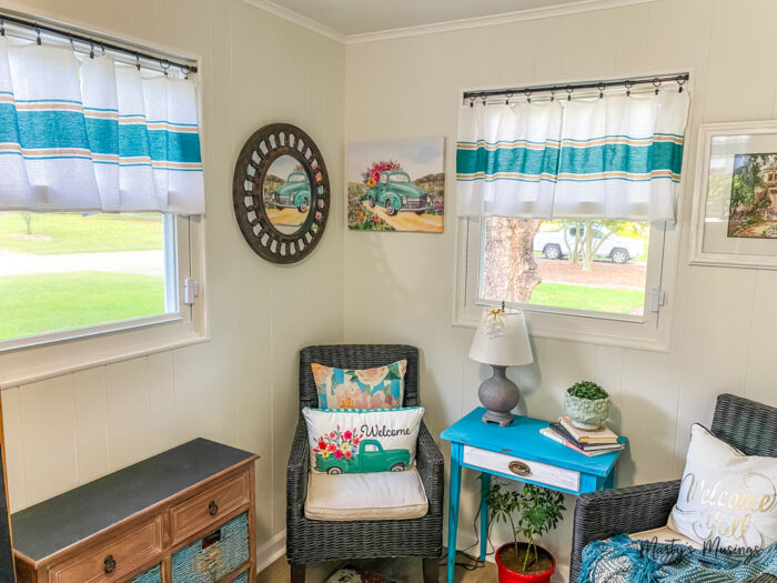 Corner of small room with colorful curtains and furnishings.