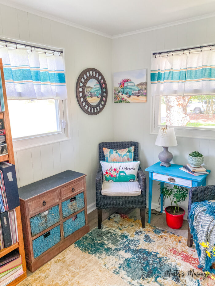 Small corner of room with bright furnishings and curtains