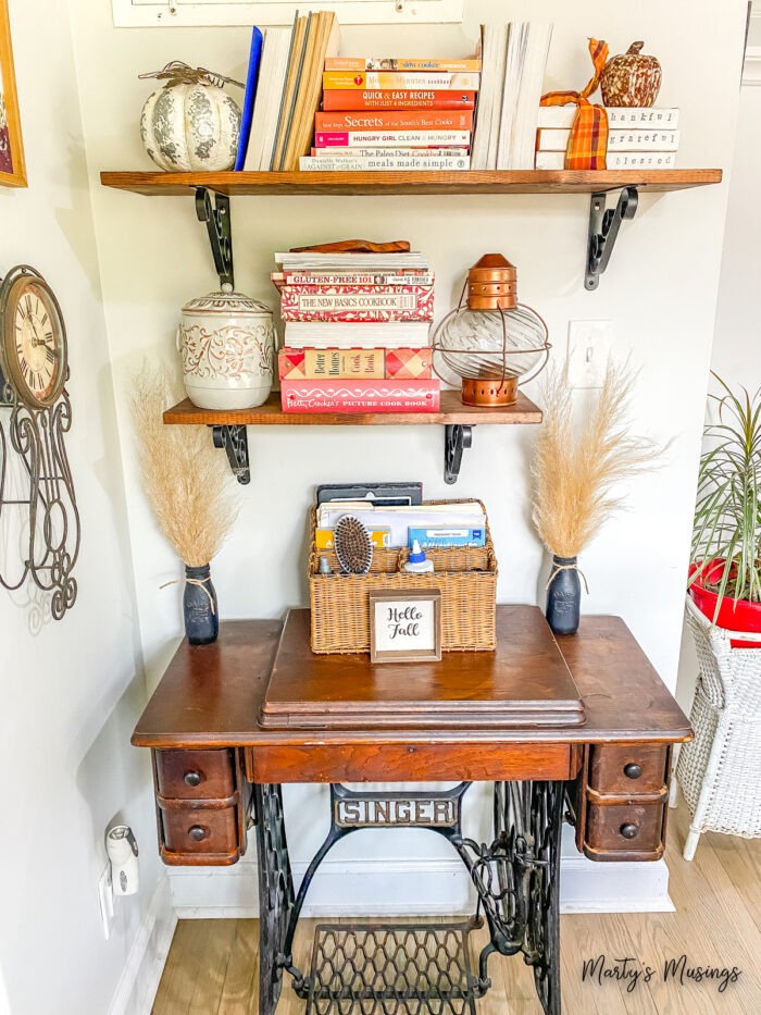 Open shelves with cookbooks and fall decor