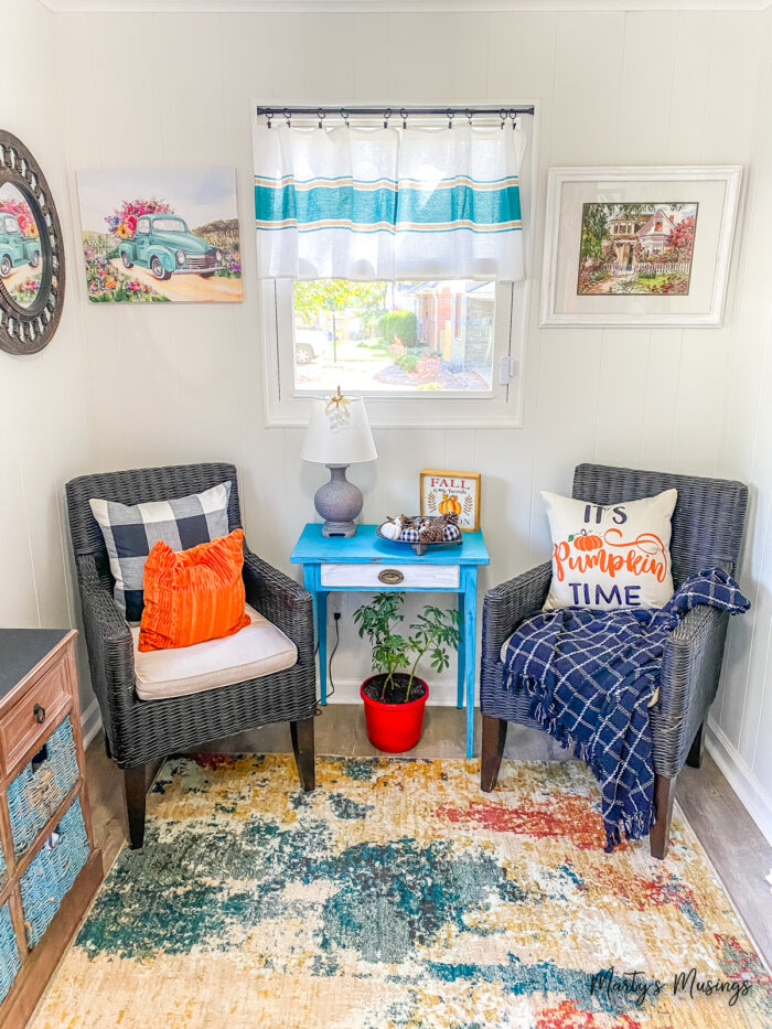 Black wicker chairs decorated for fall with buffalo plaid