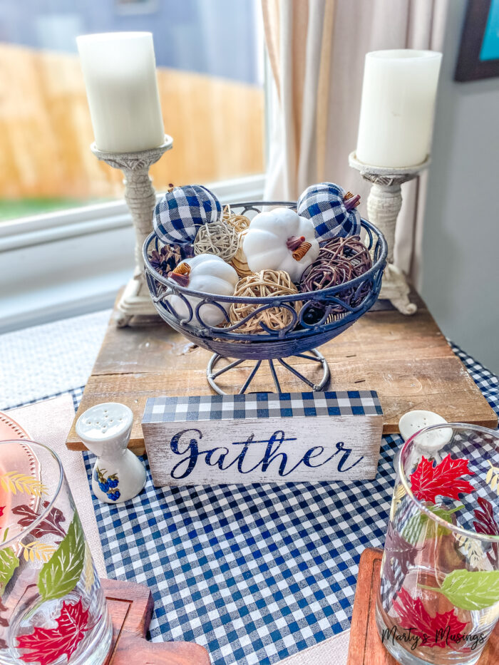 Gather sign on small table with checked runner