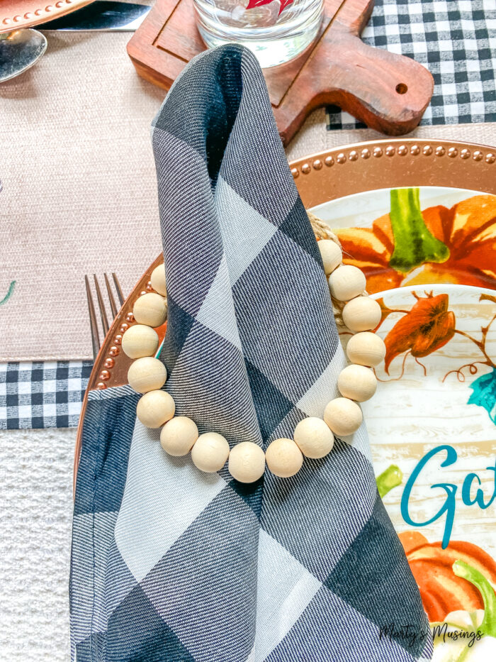 Fall place setting with blue and orange grateful plates and buffalo check napkins