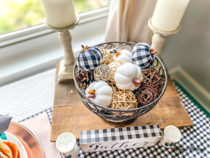 Metal basket with black and white buffalo check fabric pumpkins