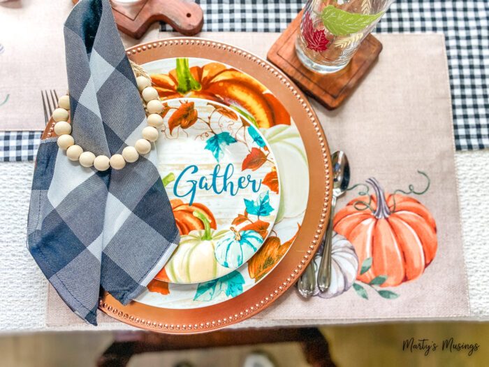 Blue and orange gather plates with black and white buffalo plaid napkins