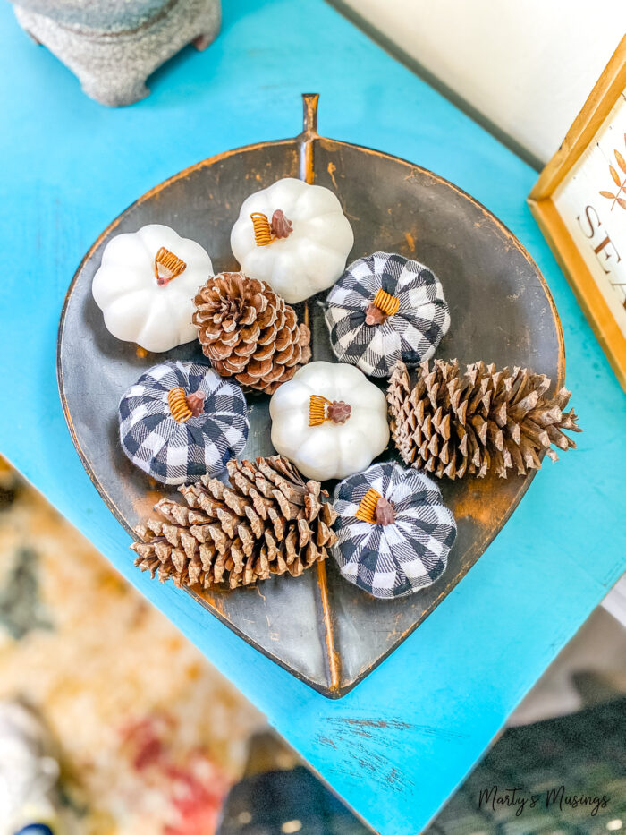 Metal leaf plate with fabric pumpkins and pinecones