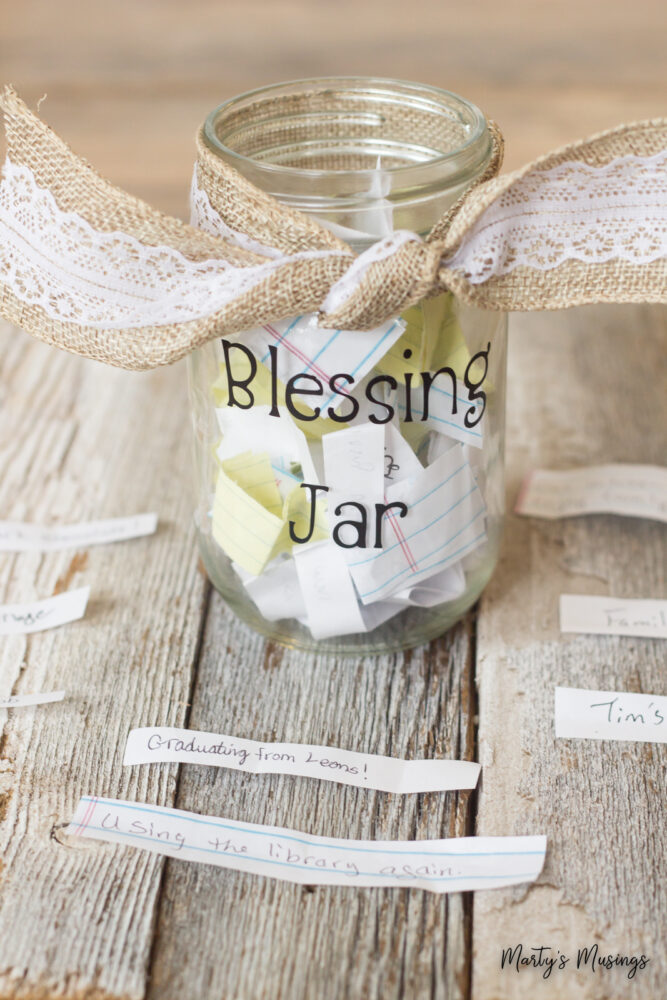 Mason jar with blessing jar on label and slips of paper inside