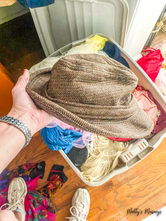 Old man's hat and tub of dress up clothes