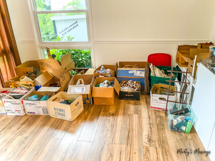 Single stacks of boxes filled with stuff in living room