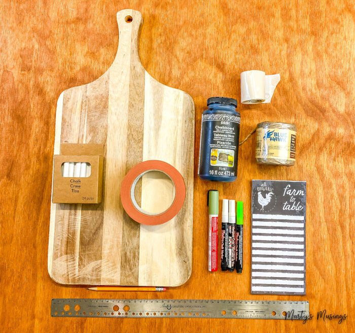 Materials to make a chalkboard sign out of a cutting board