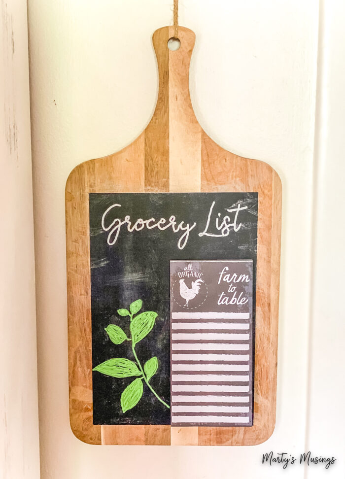 Cutting board made into chalkboard with a grocery list on it