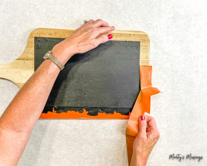 Remove tape from cutting board chalkboard sign.