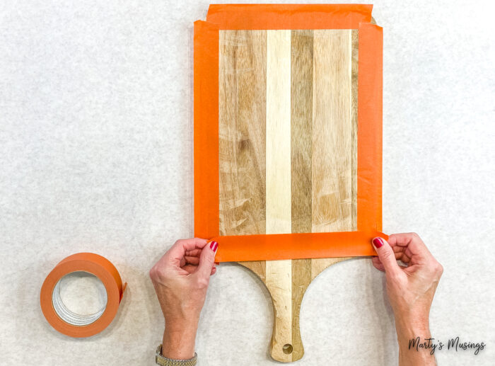 Put tape around edges of cutting board.