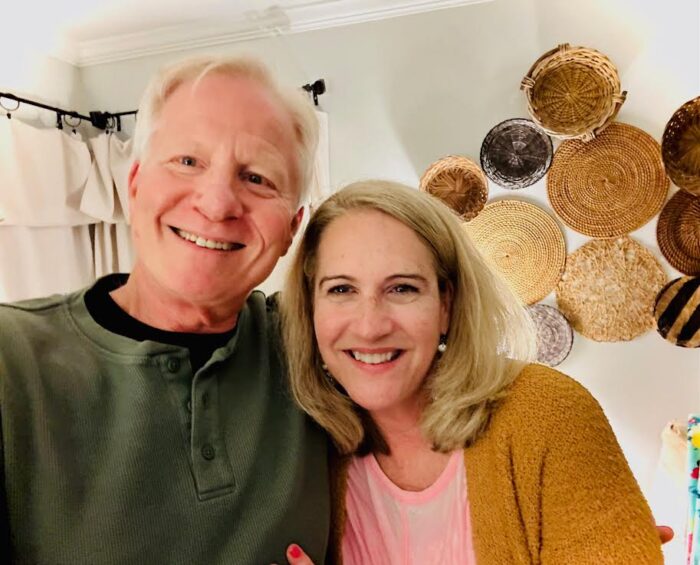 Older couple in front of basket wall taking selfie