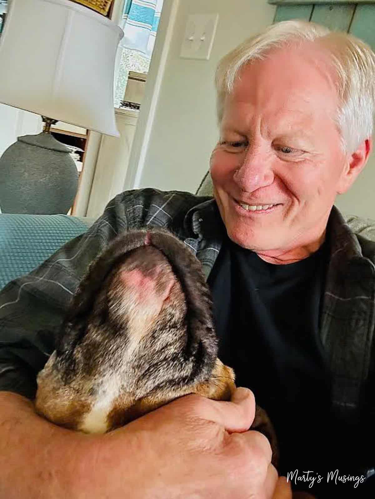 Older blonde haired man with dog