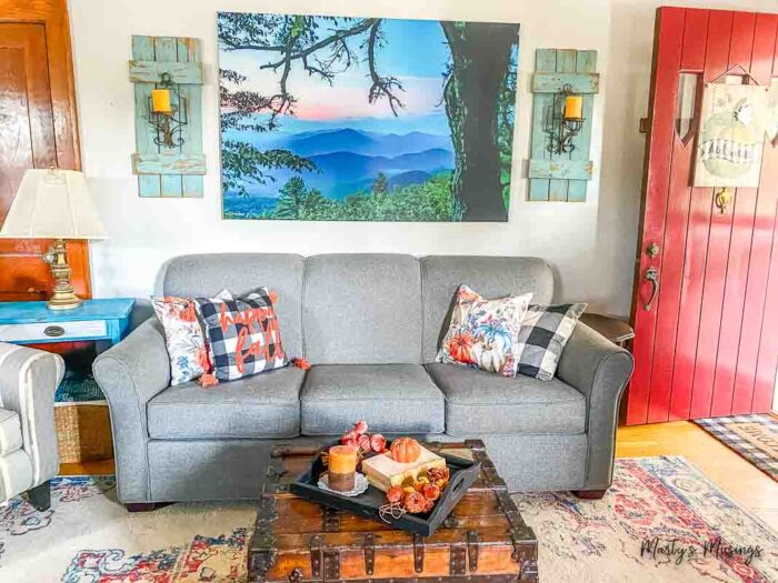 Gray couch with pops of blue and orange for fall