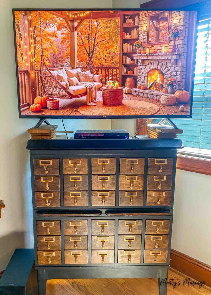 Card catalog with tv on top and fall screensaver