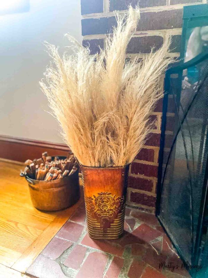 Copper vase filled with dried pompass grass stems